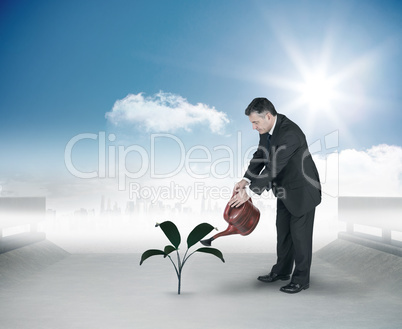 Composite image of mature businessman using watering can