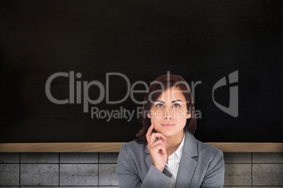 Composite image of smiling thoughtful businesswoman