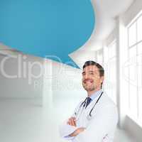 Composite image of handsome young doctor with arms crossed with