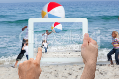 Composite image of hand holding tablet pc Composite image of hand holding tablet pc