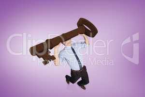 Composite image of businessman carrying large key