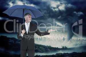 Composite image of happy businessman holding umbrella