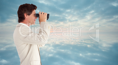 Composite image of businessman using binoculars