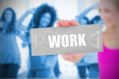 Fit blonde holding card saying work