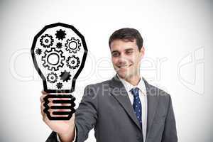 Composite image of businessman drawing light bulb