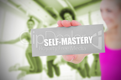 Fit blonde holding card saying self mastery