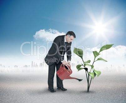 Composite image of mature businessman using watering can