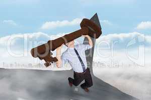 Composite image of businessman carrying large key