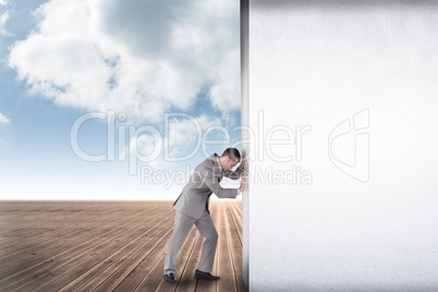 Composite image of businessman pushing away scene