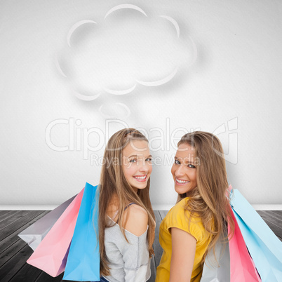 Composite image of two young women with shopping bags with speec