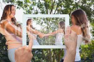 Composite image of hand holding tablet pc