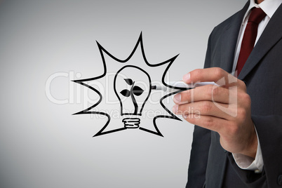 Composite image of businessman drawing light bulb