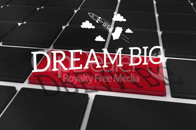 Dream big against black keyboard with red key