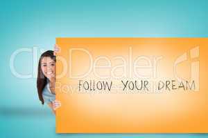 Pretty brunette showing card with follow your dream