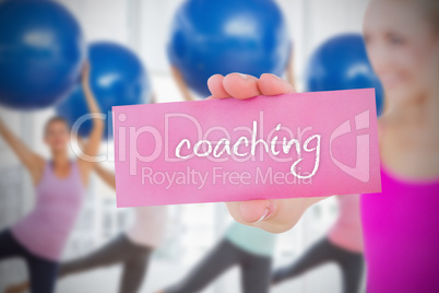 Fit blonde holding card saying coaching