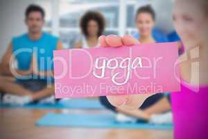 Fit blonde holding card saying yoga