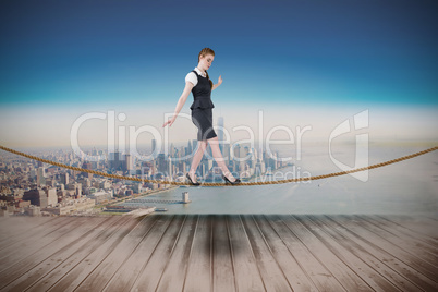 Composite image of businesswoman doing a balancing act