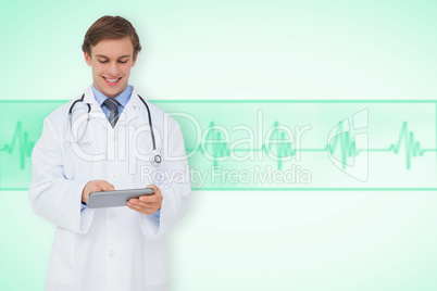 Composite image of young doctor using tablet pc