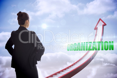 Organization against red stairs arrow pointing up against sky