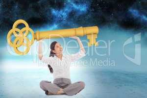 Composite image of businesswoman sitting cross legged carrying l