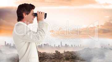 Composite image of businessman using binoculars