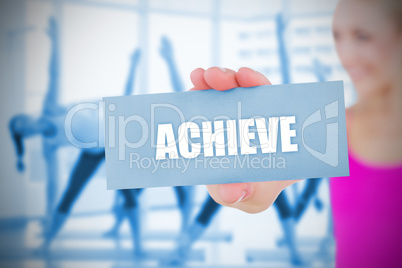 Fit blonde holding card saying achieve