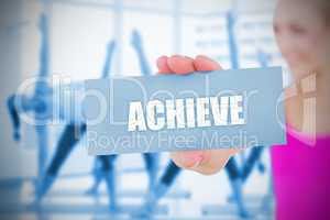 Fit blonde holding card saying achieve