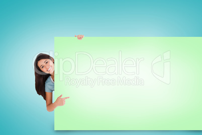 Composite image of pretty brunette showing card Composite image of pretty brunette showing card