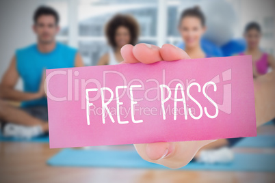 Woman holding pink card saying free class