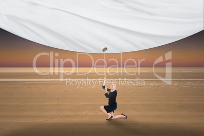 Composite image of businesswoman pulling a white screen