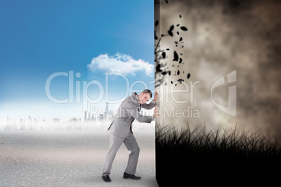 Composite image of businessman pushing away scene