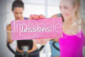 Fit blonde holding card saying lessons