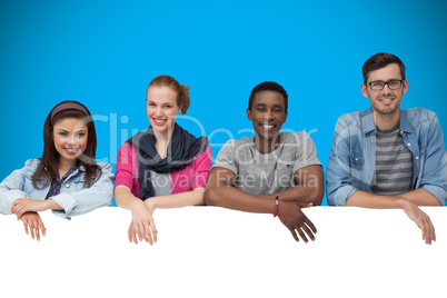 Composite image of young friends showing card