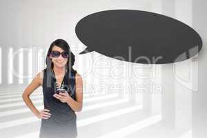 Composite image of happy brunette holding smartphone with speech