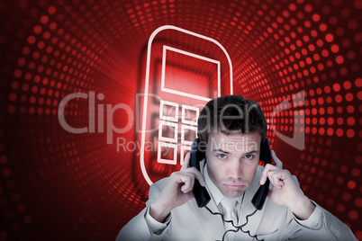 Composite image of smartphone and businessman tangled in wires