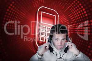 Composite image of smartphone and businessman tangled in wires