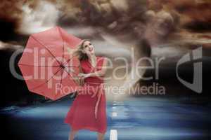 Composite image of elegant blonde holding umbrella