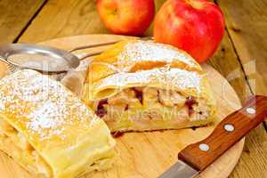 Strudel apple with strainer and knife on board