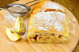 Strudel apple with strainer on board