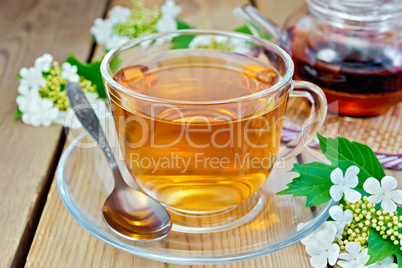 Tea from flowers of viburnum on wooden board