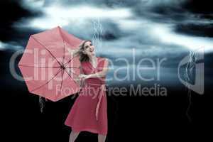 Composite image of elegant blonde holding umbrella