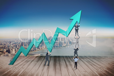 Composite image of business team holding up arrow