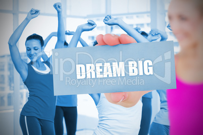 Fit blonde holding card saying dream big
