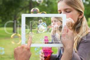 Composite image of hand holding tablet pc