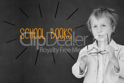 School books against schoolboy and blackboard