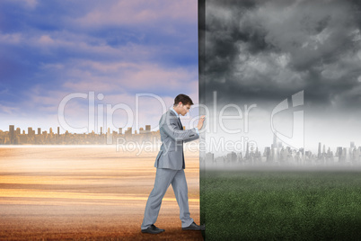 Composite image of businessman pushing away scene