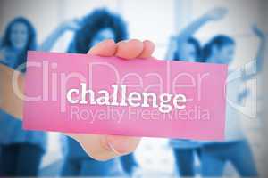 Woman holding pink card saying challenge