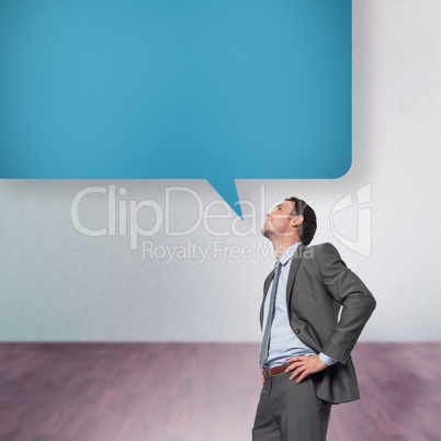 Composite image of smiling businessman with hands on hips