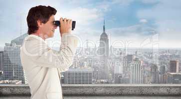 Composite image of businessman using binoculars