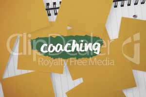 Coaching against yellow paper strewn over notepad